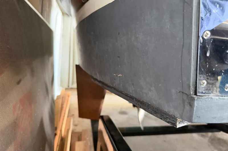 Slide: The Image of Close-up of a 1964 Shepherd 22 boat hull in a workshop setting. - 21