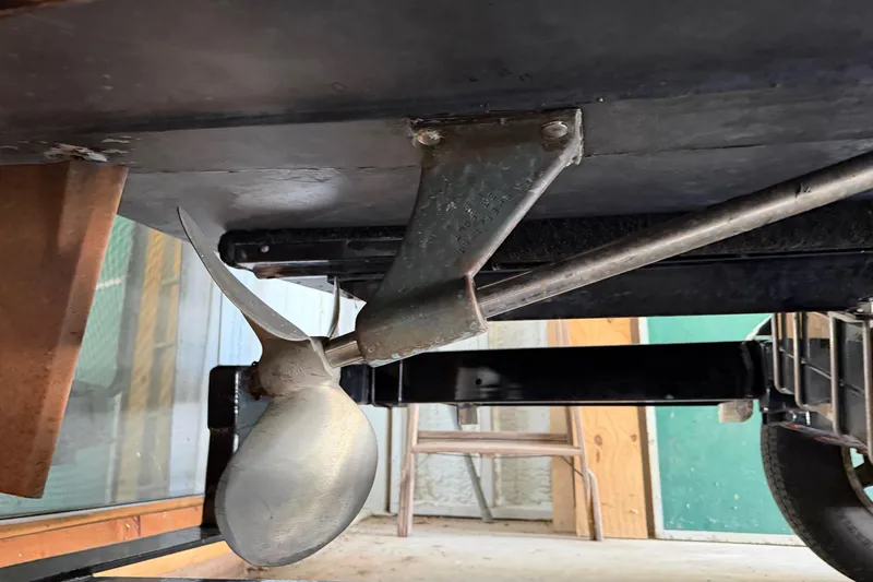 Slide: The Image of 1964 Shepherd 22 boat propeller and rudder detail in a garage setting. - 23