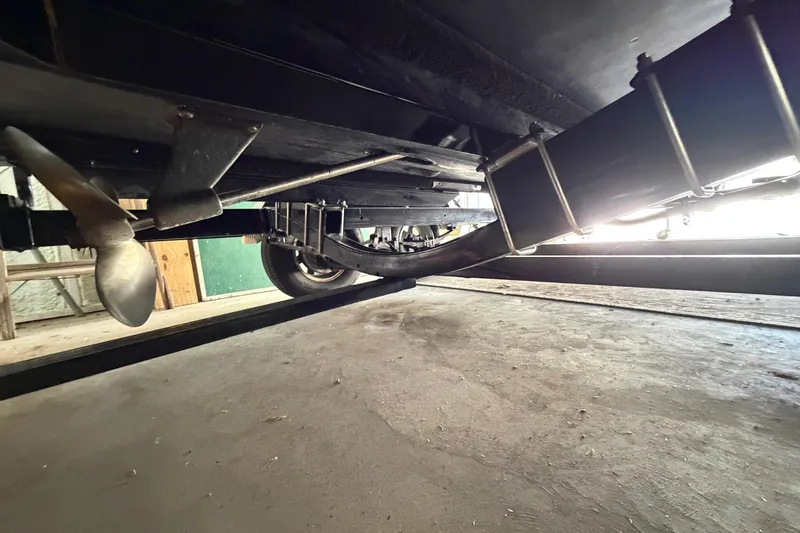 Slide: The Image of Underneath view of a 1964 Shepherd 22 boat, showcasing propeller and suspension components. - 28