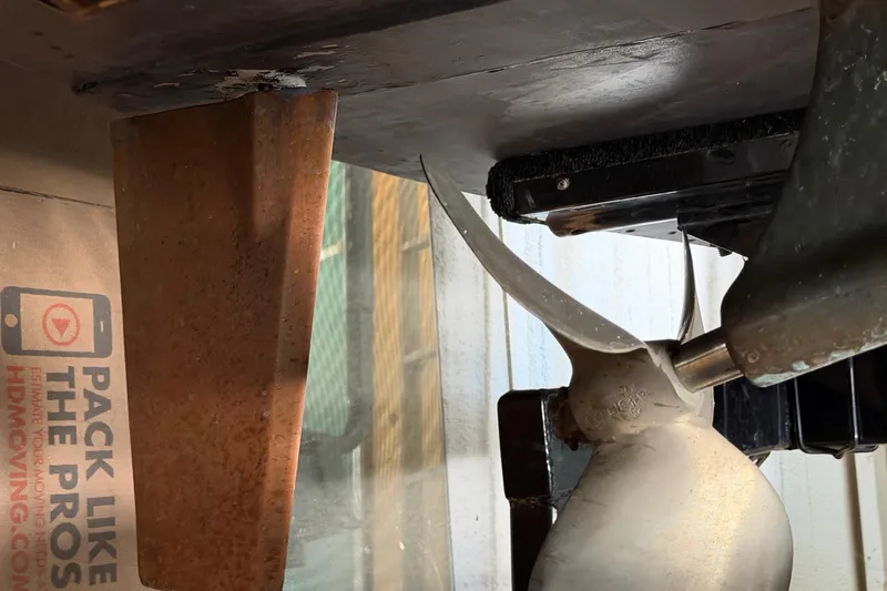 Slide: The Image of 1964 Shepherd 22 boat propeller and rudder detail in a storage setting. - 31