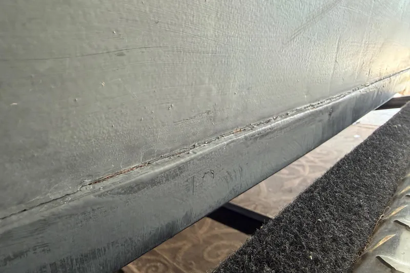 Slide: The Image of Close-up of 1964 Shepherd 22 boat hull with visible seam and textured surface. - 33