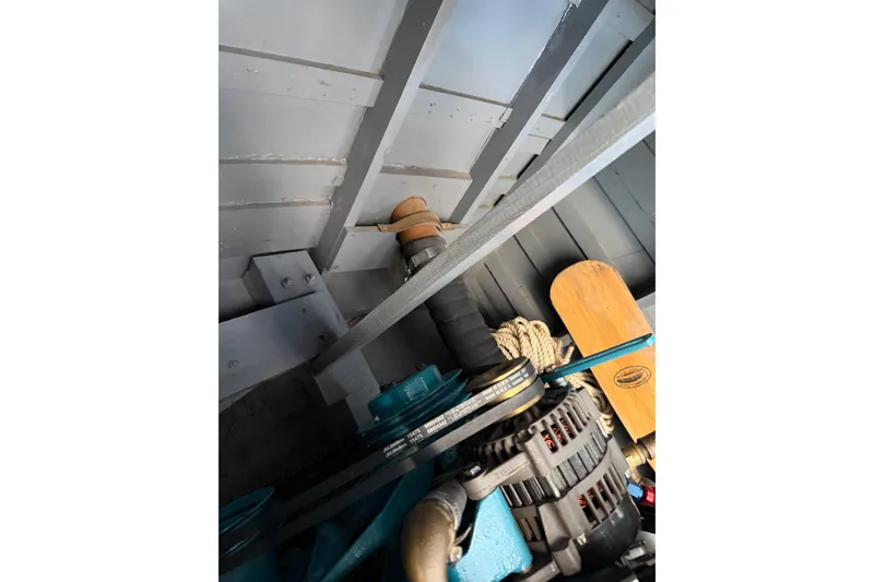 Slide: The Image of 1964 Shepherd 22 engine compartment with visible belts and wooden paddle. - 37