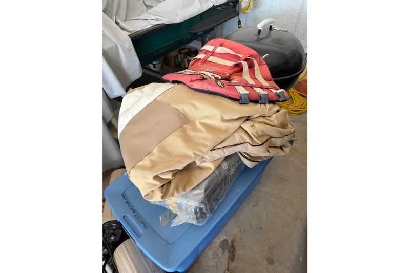 Slide: The Image of Old life jacket and tarp on storage box, near a grill, Shepherd 22, 1964. - 38