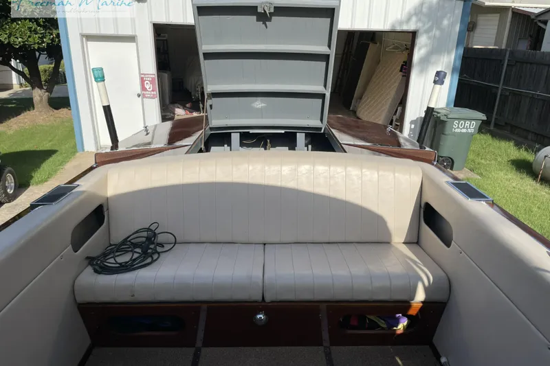Slide: The Image of 1964 Shepherd 22 boat interior with beige seating and open engine compartment. - 5