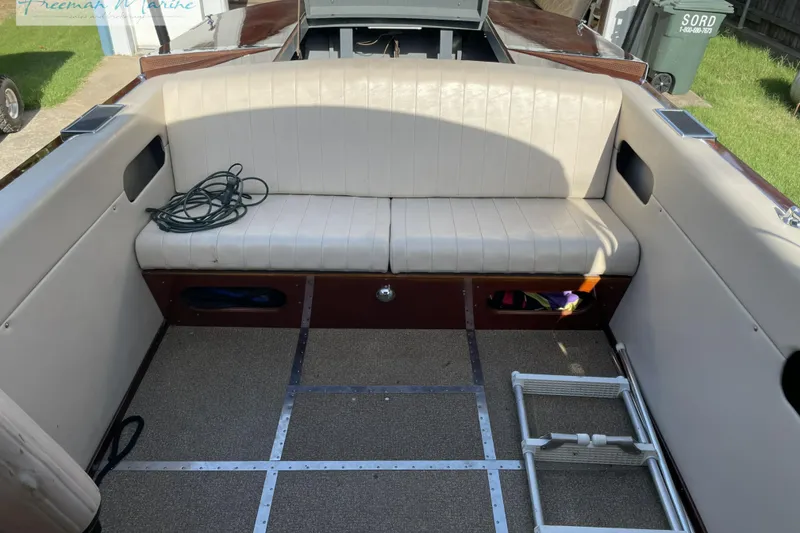 Slide: The Image of 1964 Shepherd 22 boat interior with white seating and storage compartments. - 6