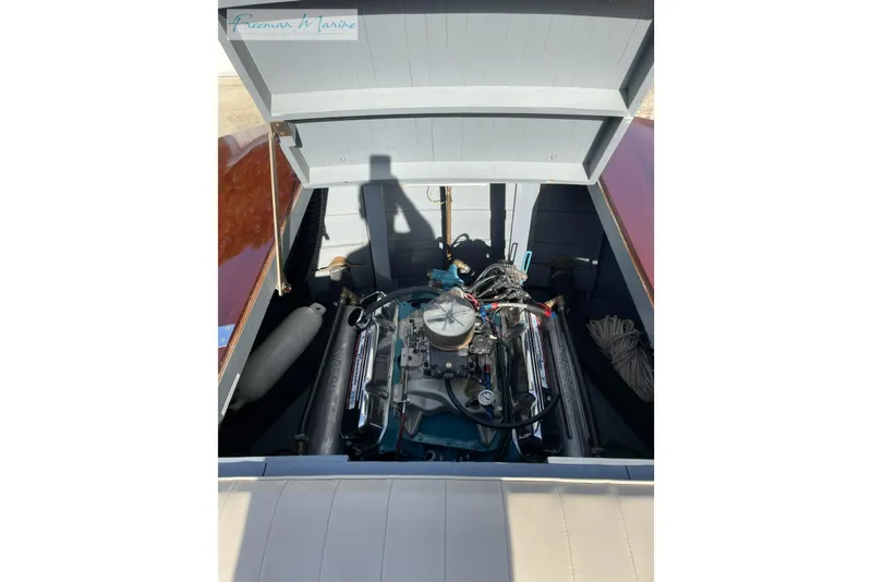 Slide: The Image of 1964 Shepherd 22 boat engine compartment with visible engine and ropes. - 7