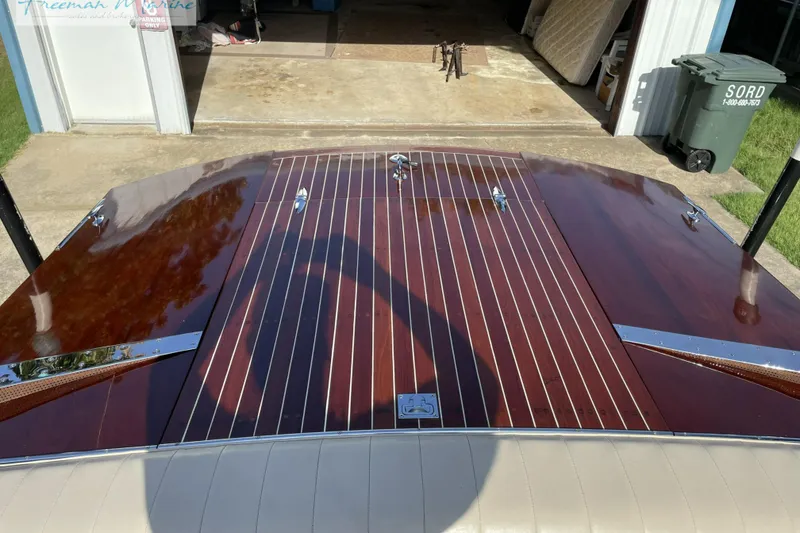Slide: The Image of 1964 Shepherd 22 boat with polished wooden deck in a garage setting. - 9