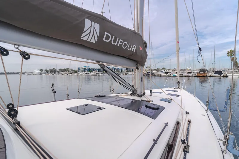 Slide: The Image of 2024 Dufour 470 sailboat docked in a marina, showcasing sleek design and modern features. - 20