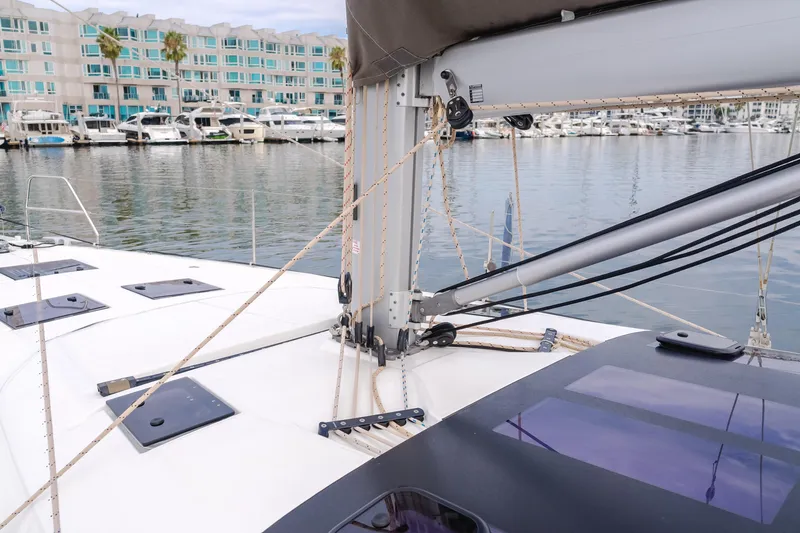 Slide: The Image of 2024 Dufour 470 sailboat deck with marina view, featuring rigging and modern design. - 21