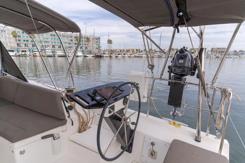 Slide: The Image of 2024 Dufour 470 yacht cockpit with steering wheel, marina view, and modern navigation equipment. - 22