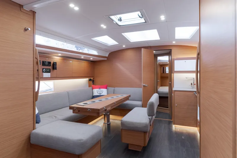 Slide: The Image of Luxurious interior of 2024 Dufour 470 yacht with modern seating and wooden finishes. - 28