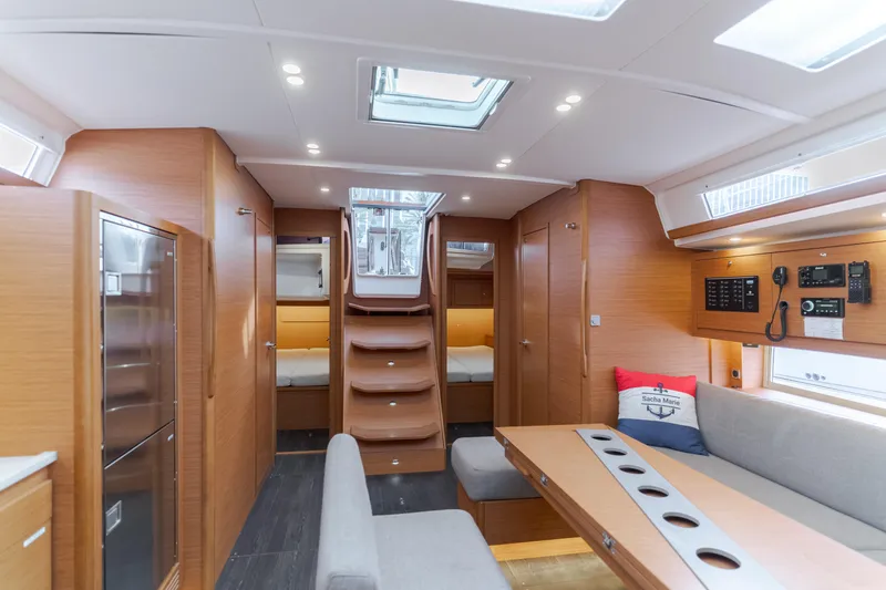 Slide: The Image of Luxurious interior of 2024 Dufour 470 yacht with modern wood finish and seating area. - 29