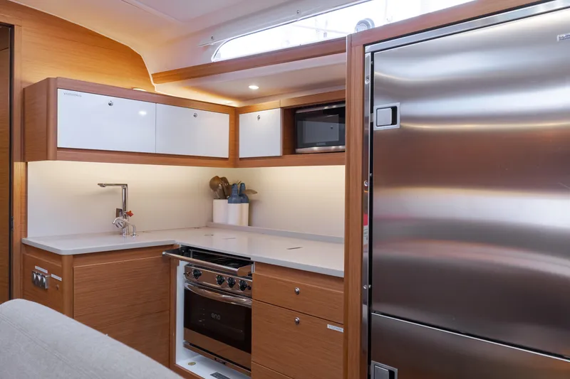 Slide: The Image of Modern kitchen interior of 2024 Dufour 470 yacht with sleek appliances and wood finish. - 33