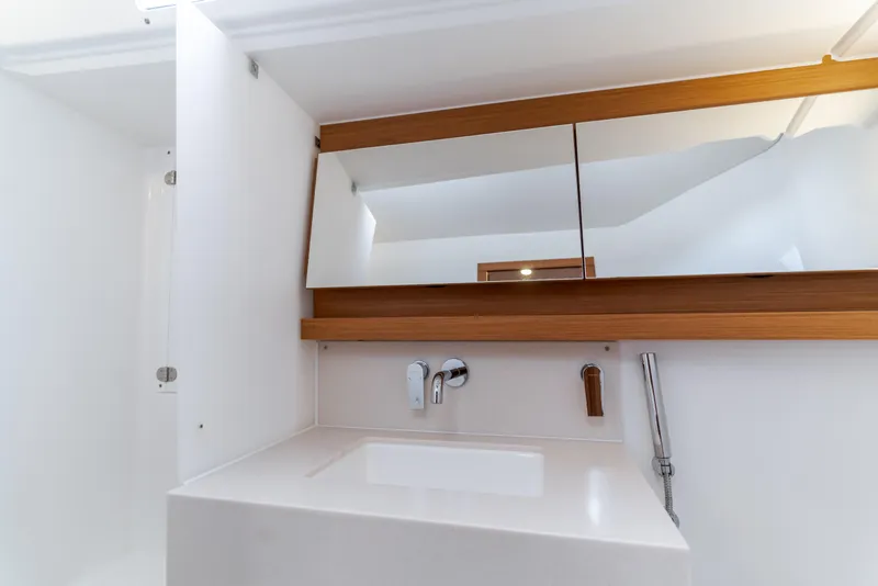 Slide: The Image of Modern bathroom interior of 2024 Dufour 470 yacht with sleek design and wooden accents. - 44