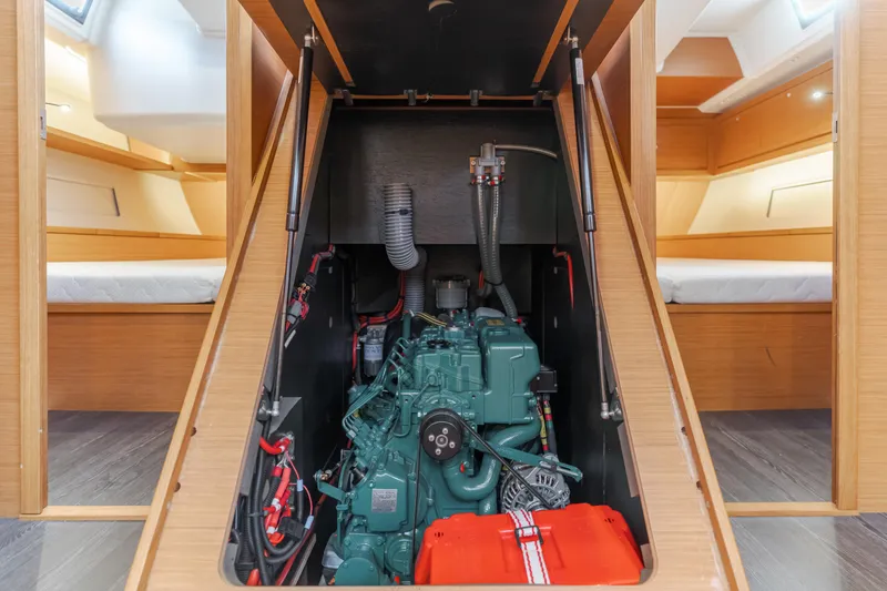 Slide: The Image of 2024 Dufour 470 yacht engine compartment with visible engine and cabin interior. - 45