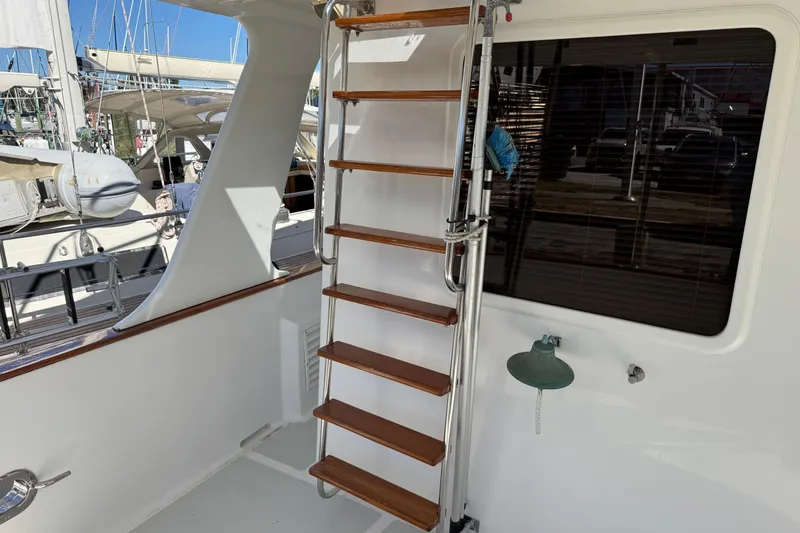 Slide: The Image of Staircase on 2006 DeFever 52 Euro yacht, docked with sailboats in background. - 13