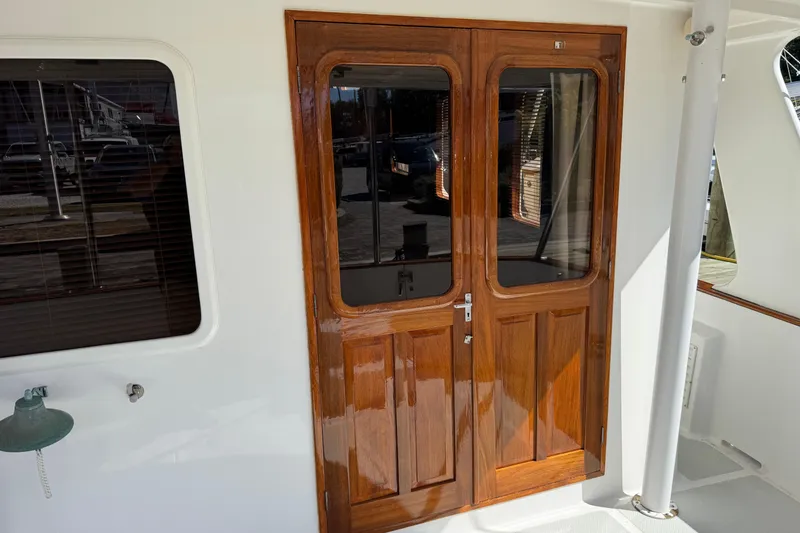 Slide: The Image of Polished wooden doors on a 2006 DeFever 52 Euro yacht, reflecting sunlight. - 14