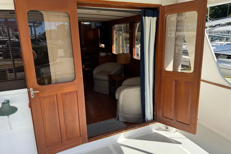 Slide: The Image of 2006 DeFever 52 Euro yacht interior with wooden doors and cozy seating area. - 15