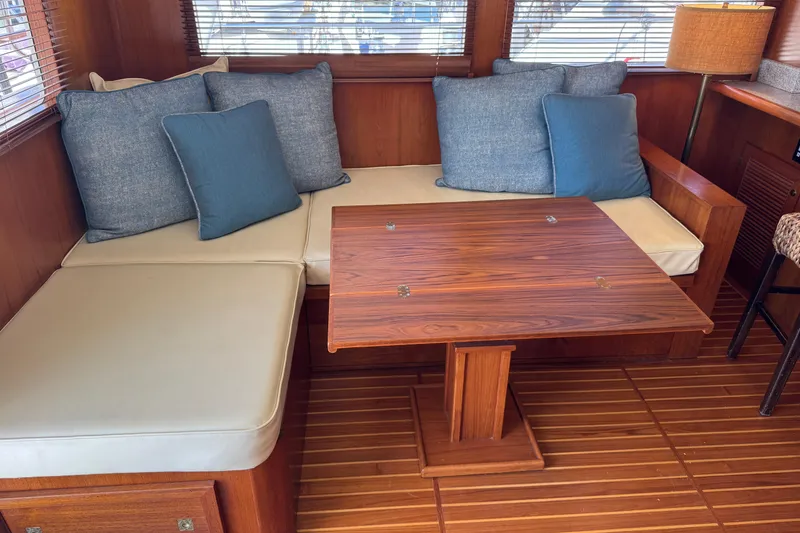Slide: The Image of Luxurious 2006 DeFever 52 Euro yacht interior with cozy seating and elegant wooden table. - 20