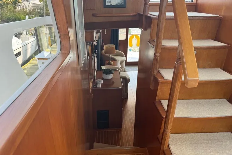 Slide: The Image of Interior of 2006 DeFever 52 Euro yacht with wooden stairs and cozy seating area. - 29