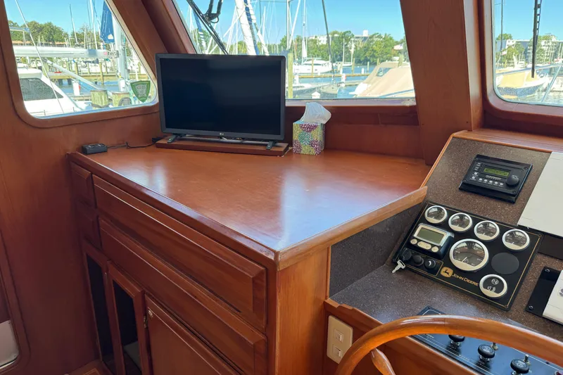 Slide: The Image of 2006 DeFever 52 Euro yacht helm with wooden cabinetry and navigation instruments. - 32