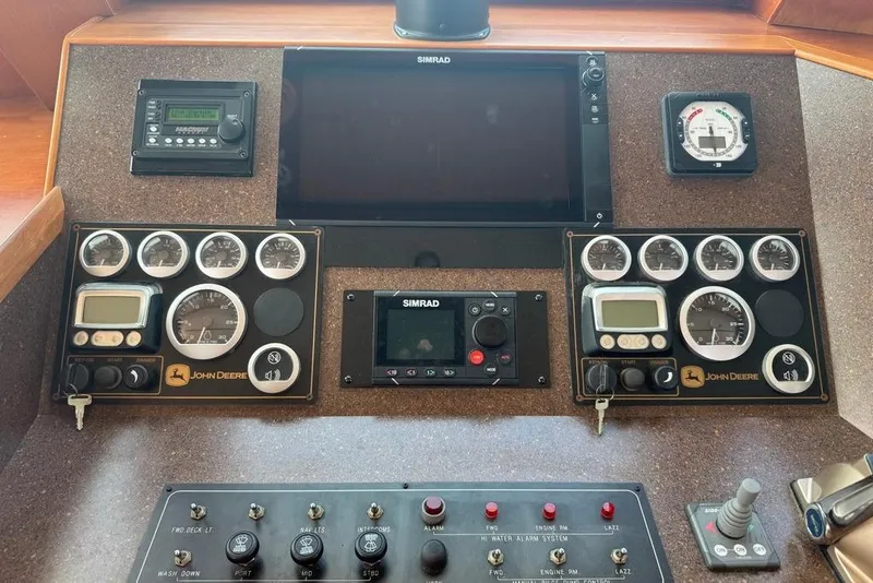 Slide: The Image of Control panel of a 2006 DeFever 52 Euro yacht with John Deere gauges and Simrad display. - 36