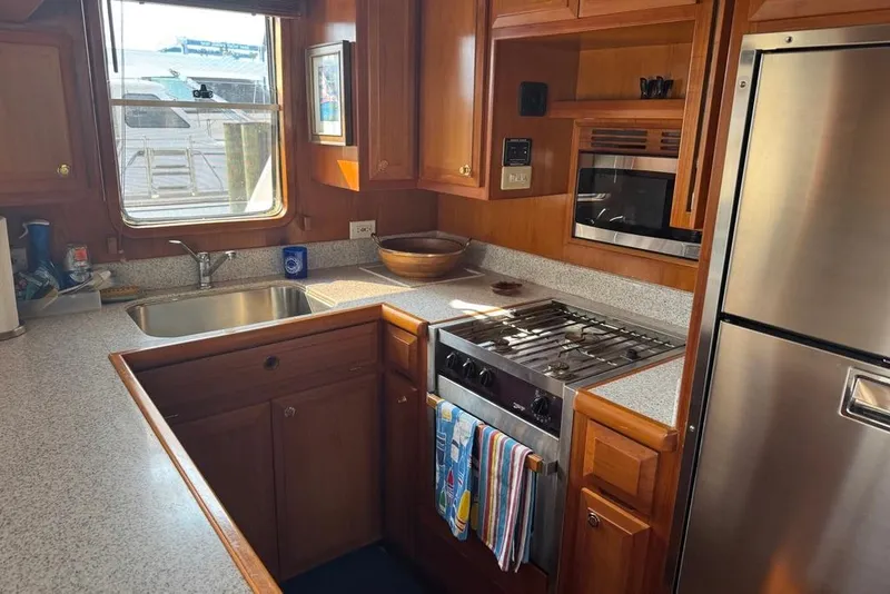 Slide: The Image of Galley kitchen in 2006 DeFever 52 Euro yacht with stainless steel appliances. - 4