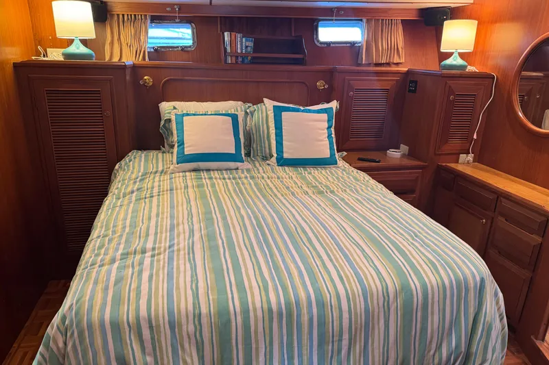 Slide: The Image of Cozy bedroom in 2006 DeFever 52 Euro yacht with striped bedding and wooden cabinetry. - 41