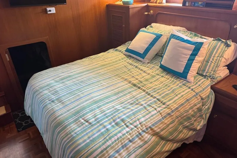 Slide: The Image of Cozy bedroom with striped bedding in 2006 DeFever 52 Euro yacht interior. - 42