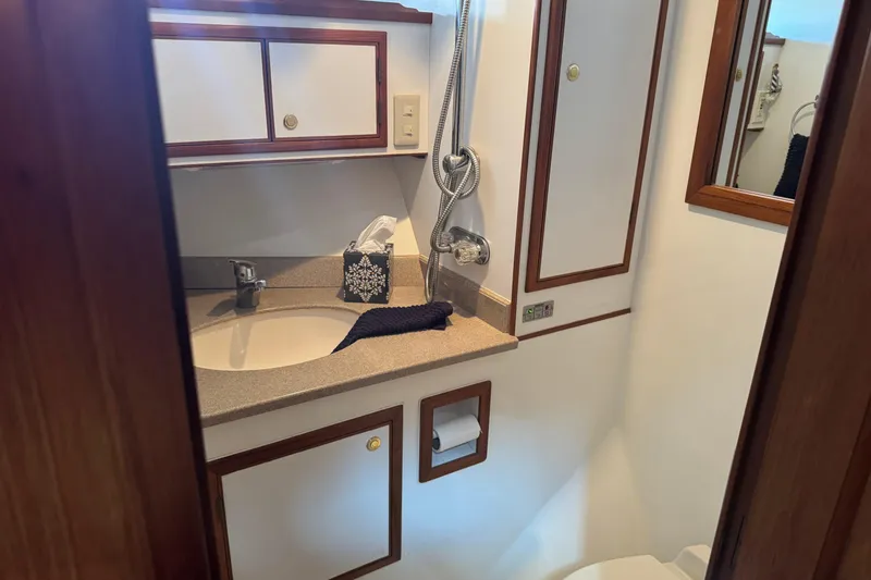 Slide: The Image of Bathroom interior of 2006 DeFever 52 Euro yacht with sink, mirror, and storage cabinets. - 46