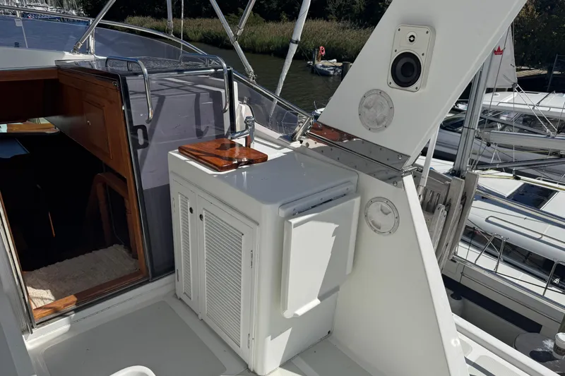 Slide: The Image of 2006 DeFever 52 Euro yacht deck with outdoor sink and storage cabinet. - 48