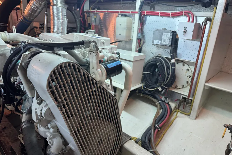 Slide: The Image of Engine room of 2006 DeFever 52 Euro yacht, showcasing mechanical components and wiring. - 52