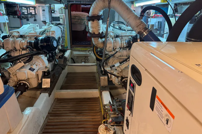 Slide: The Image of Engine room of 2006 DeFever 52 Euro yacht, showcasing dual engines and mechanical systems. - 53