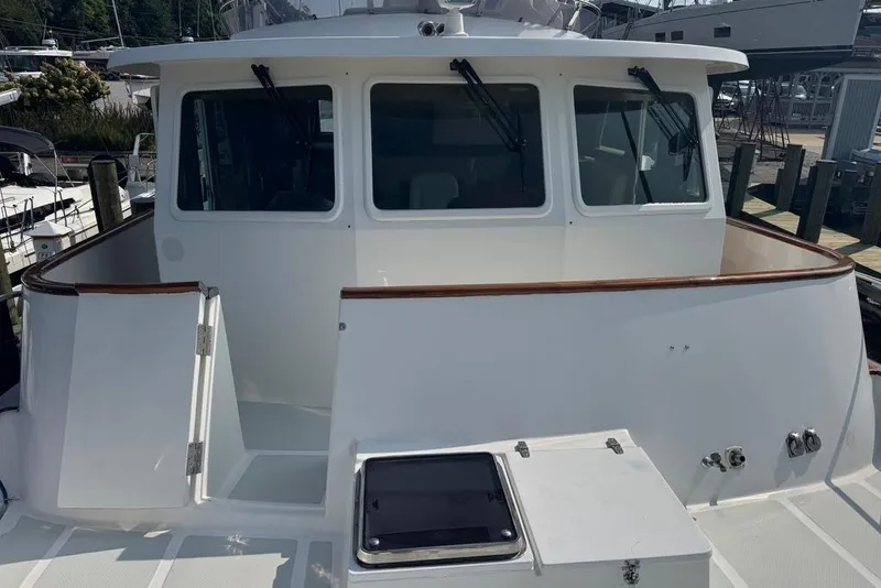 Slide: The Image of 2006 DeFever 52 Euro yacht, featuring a spacious deck and sleek design. - 6