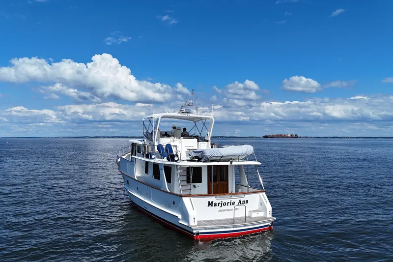 Slide: The Image of 2006 DeFever 52 Euro yacht on open water under a clear blue sky. - 60