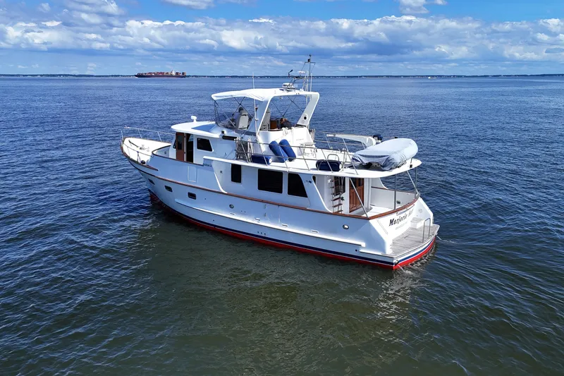 Slide: The Image of 2006 DeFever 52 Euro yacht on calm ocean waters under a blue sky. - 61
