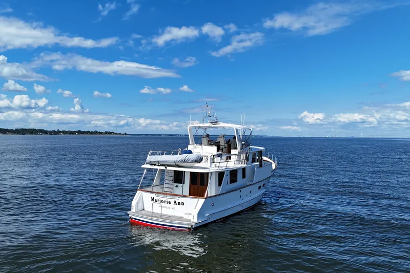 Slide: The Image of 2006 DeFever 52 Euro yacht on open water under a clear blue sky. - 63