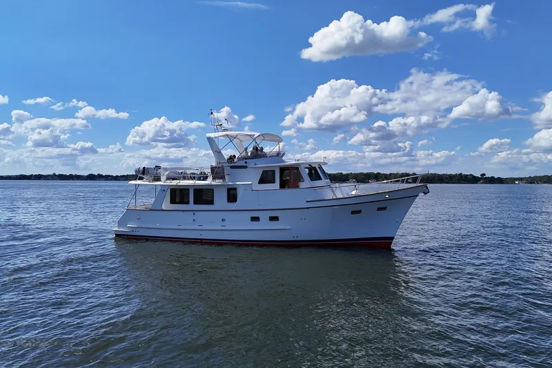 Slide: The Image of 2006 DeFever 52 Euro yacht on calm water under a blue sky with clouds. - 65