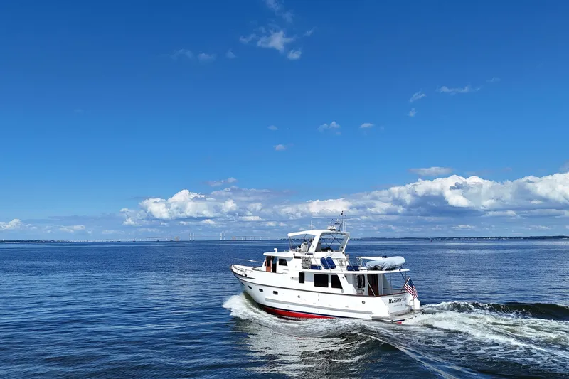 Slide: The Image of 2006 DeFever 52 Euro yacht cruising on open water under a clear blue sky. - 67