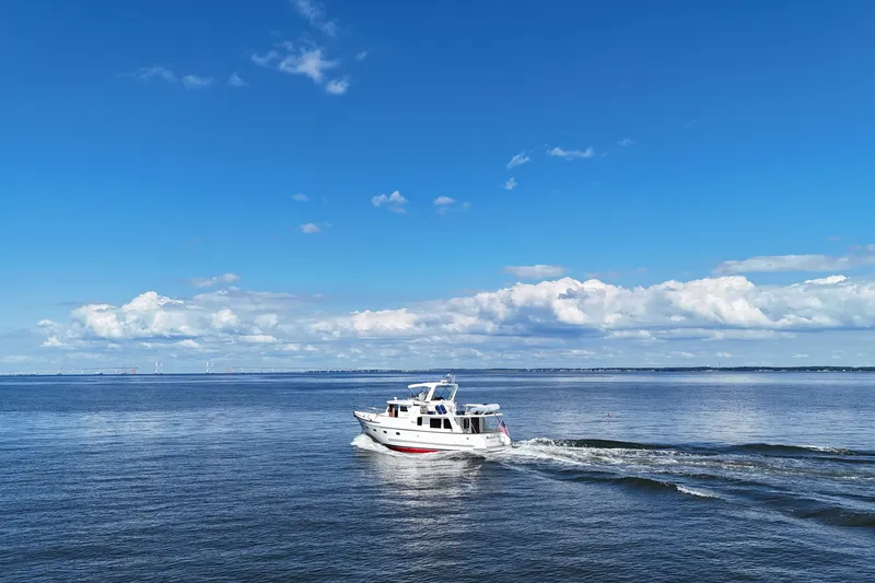 Slide: The Image of 2006 DeFever 52 Euro yacht cruising on a calm, blue ocean under a clear sky. - 69