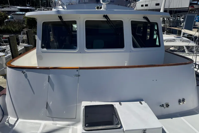 Slide: The Image of 2006 DeFever 52 Euro yacht, white exterior, docked at marina. - 7