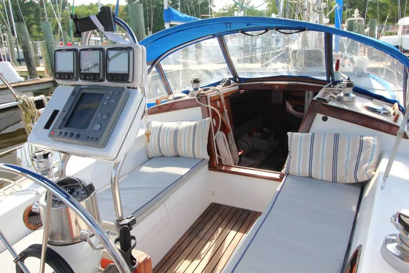 Slide: The Image of 1987 Catalina 34 sailboat cockpit with navigation equipment and cushioned seating. - 13
