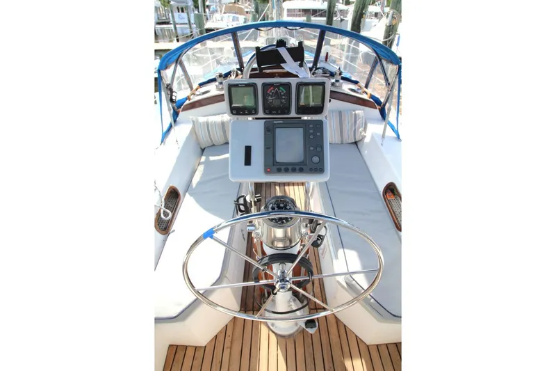 Slide: The Image of Cockpit of a 1987 Catalina 34 sailboat with navigation instruments and steering wheel. - 14