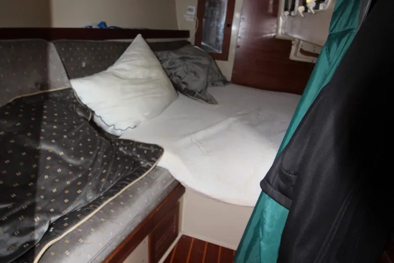 Slide: The Image of Cozy cabin interior of 1987 Catalina 34 sailboat with bed and pillows. - 18