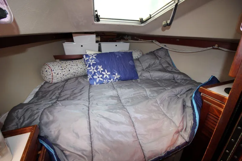Slide: The Image of Cozy cabin interior of 1987 Catalina 34 sailboat with bed and pillows. - 21