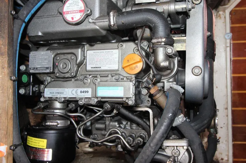 Slide: The Image of Engine compartment of a 1987 Catalina 34 sailboat, featuring a Yanmar marine engine. - 23