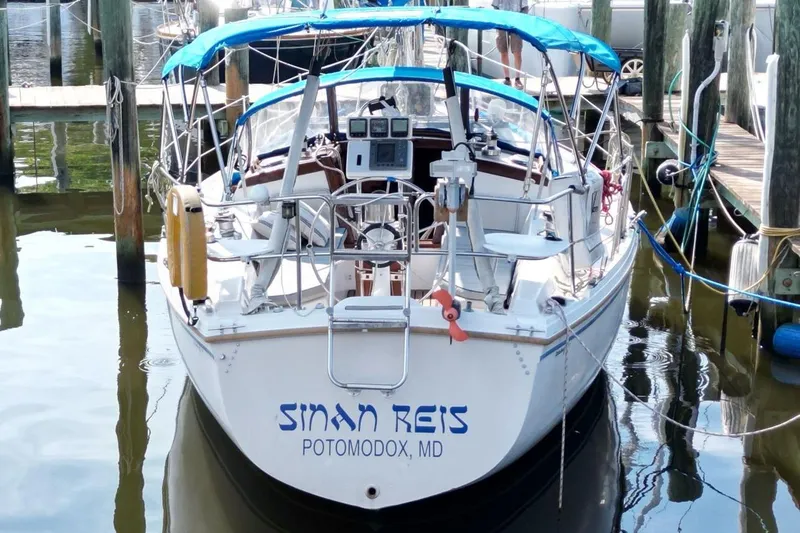 Slide: The Image of Catalina 34 sailboat, 1987 model, docked with blue canopy and visible equipment. - 5