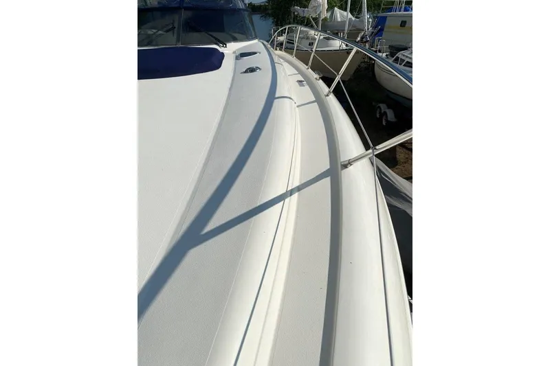 Slide: The Image of 1998 Sunseeker Predator 58 yacht deck with sleek design and railing. - 13