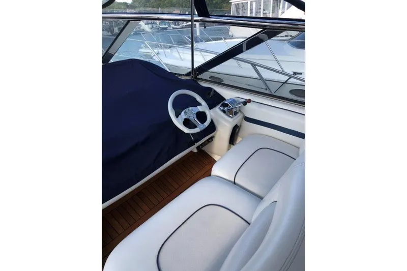 Slide: The Image of 1998 Sunseeker Predator 58 yacht cockpit with steering wheel and seating. - 15