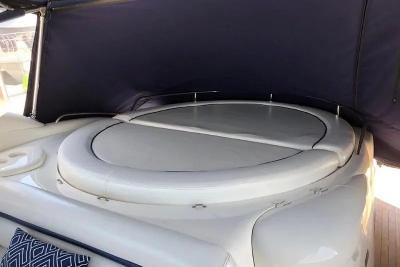 Slide: The Image of Sunseeker Predator 58 yacht, 1998 model, featuring a luxurious sunbed under a canopy. - 22